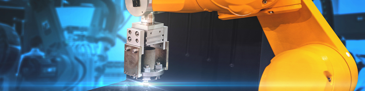 An orange industrial robotic arm with a metal gripper in a factory, against a blue-toned background with blurred machinery.