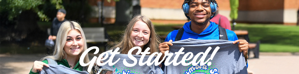 Group of students holding t-shirts outside