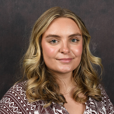 Profile photo of Katelynn Massey, a Marketing and Customized Training Support Coordinator, in front of a professional backdrop.