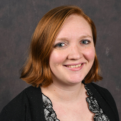 Profile photo of Jane Adele Scott, Business and Technology Division secretary, in front of a professional backdrop.