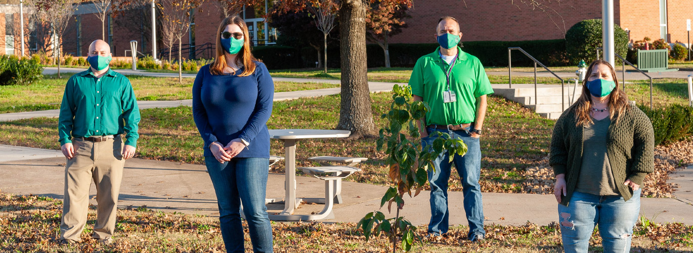 People stand in front of tree on Columbia State campus