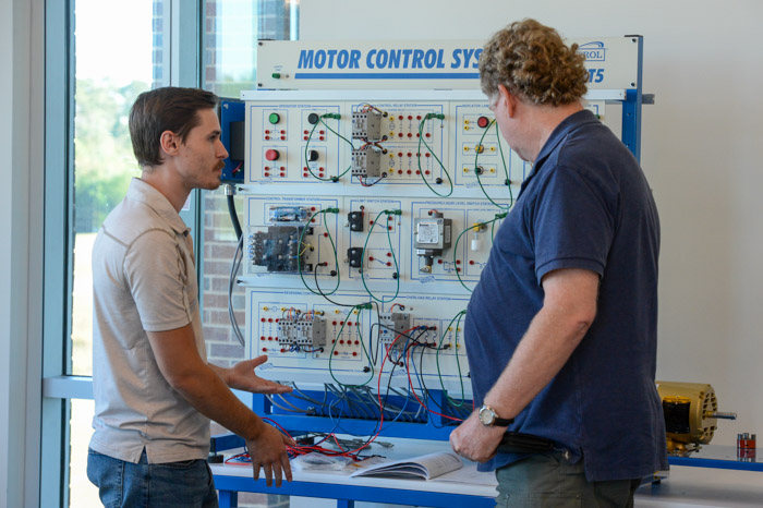 Nicholas Wilkes, Columbia State instructor of Engineering Systems Technology (left), showcases the new motor control system workstation in the new Lawrence Campus EST lab area.