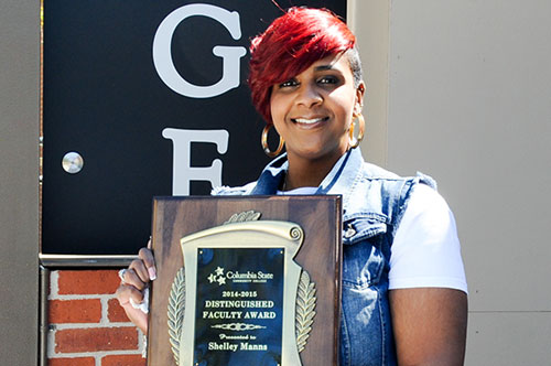 Shelley holding her distinguished faculty award